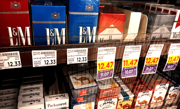 A shelf full of cigarettes being sold at a Ralph\'s grocery store.